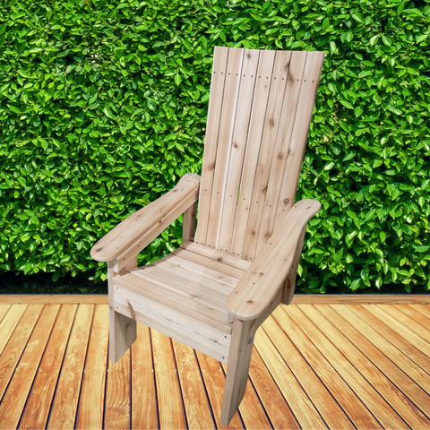 Muskoka chair on a wood deck with green hedges behind.